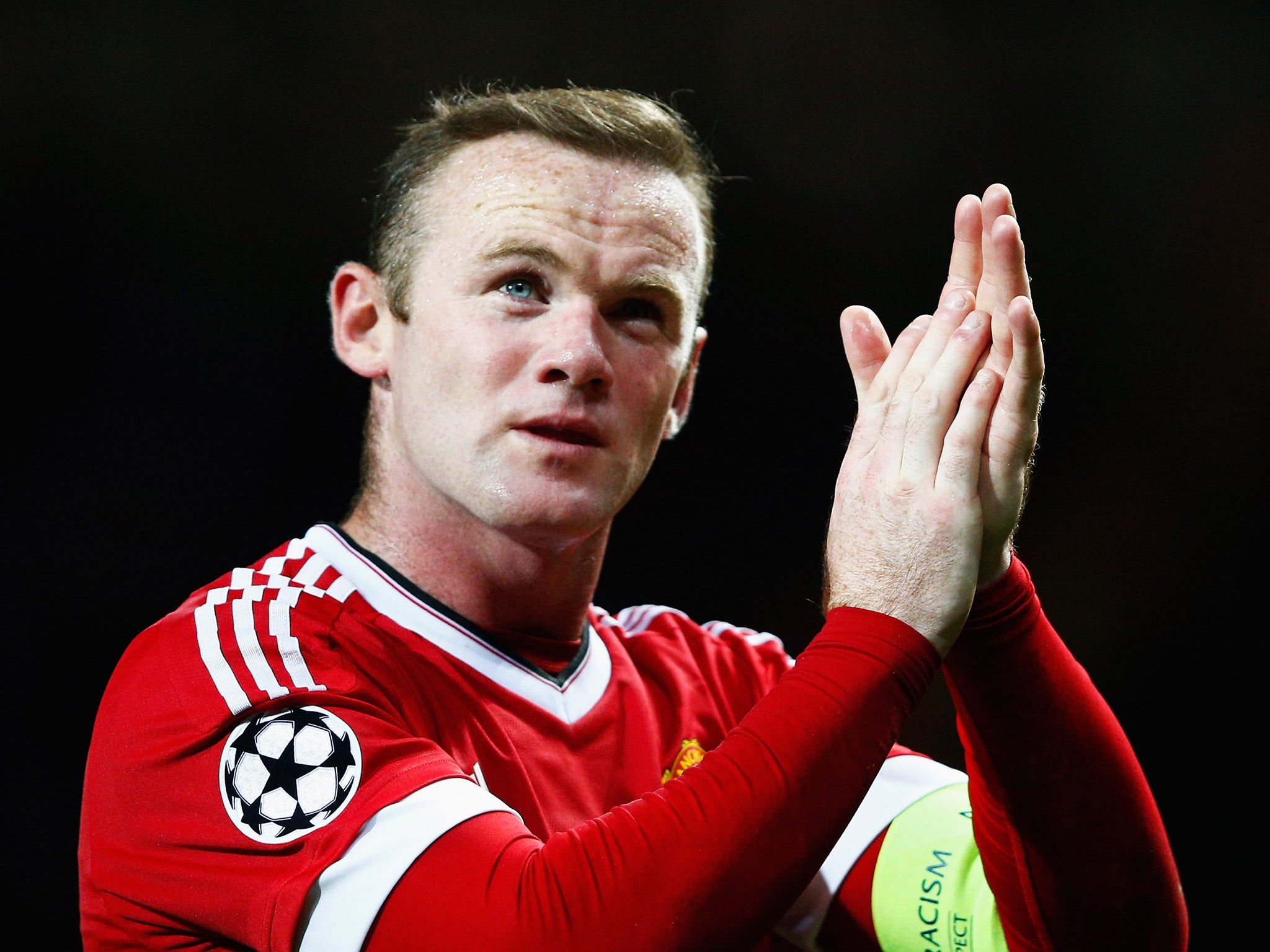 Wayne Rooney applauds the United fans after the Wolfsburg victory