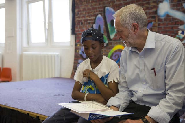 Jeremy Corbyn presents pupils with certificates after they perform in a play on their last day of school at Duncombe Primary School on July 16, 2015 in London, England.