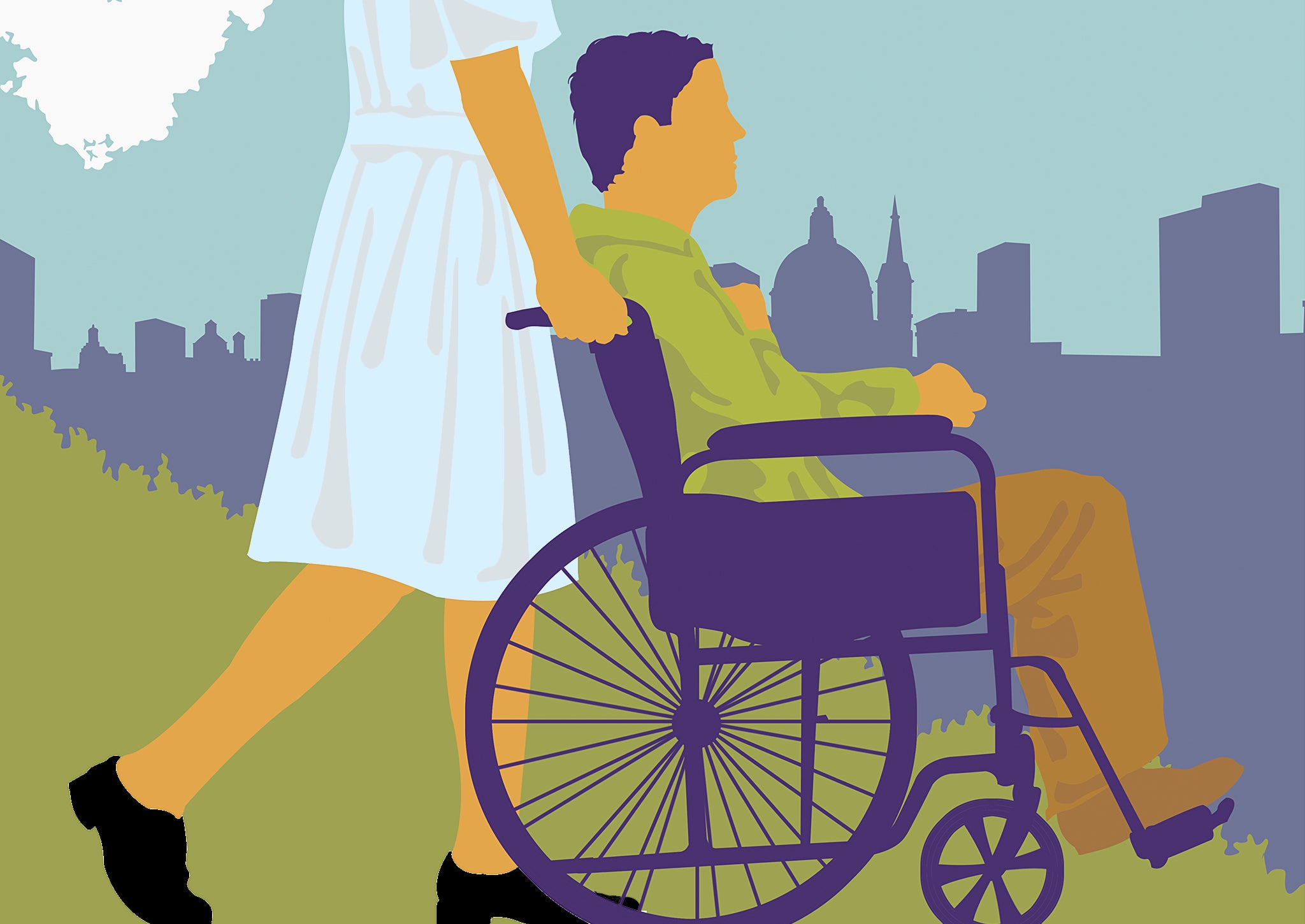 A woman pushes a man in a wheelchair through a city park