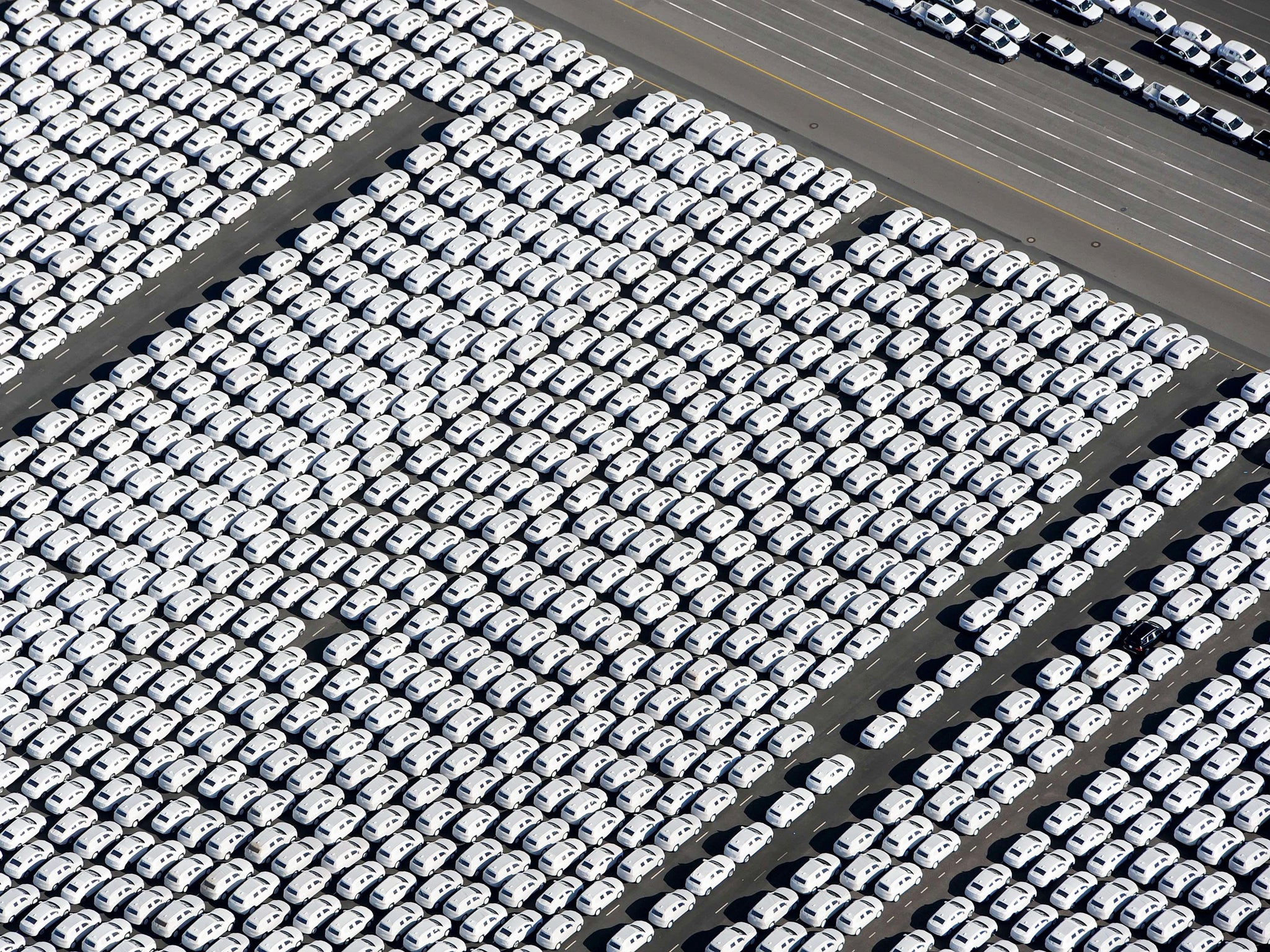 New cars of German car maker Volkswagen (VW) stand ready for shipping next to the Volkswagen plant in Emden, northwestern Germany. Volkswagen, the world's biggest carmaker by sales, has admitted that up to 11 million diesel cars worldwide are fitted with devices that can switch on pollution controls when they detect the car is undergoing testing