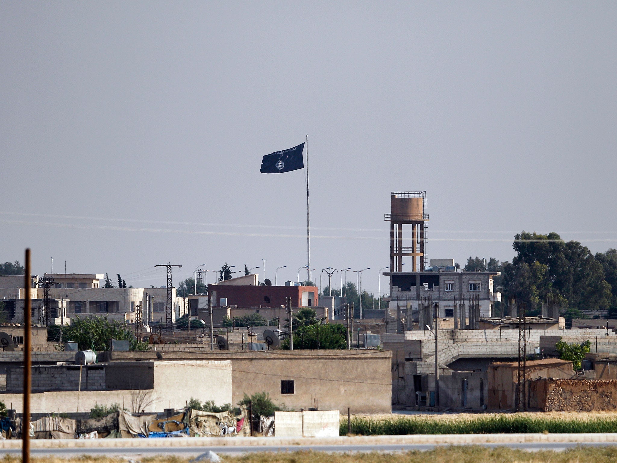 An Islamic State flag flies in the northern Syrian town of Tel Abyad