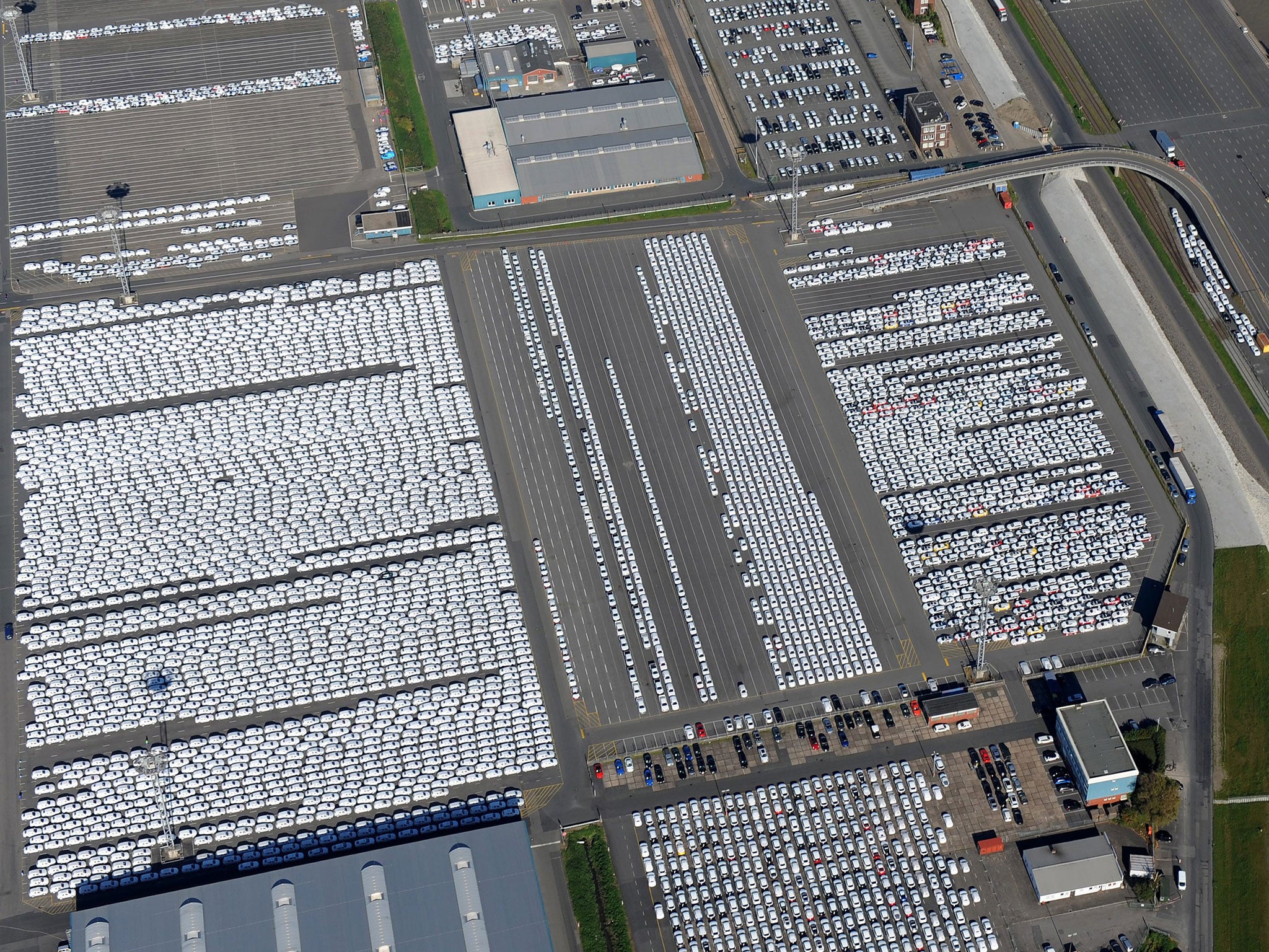 Brand new cars are gathered at a giant parking lot, ready to be shipped near the pier of the car terminal next to the Volkswagon plant in Emden, Germany