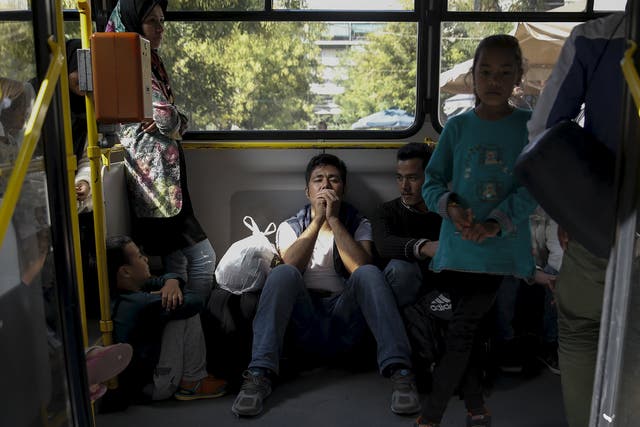 Afghan refugees are on a bus as they are transferred from Victoria Square to Galatis stadium