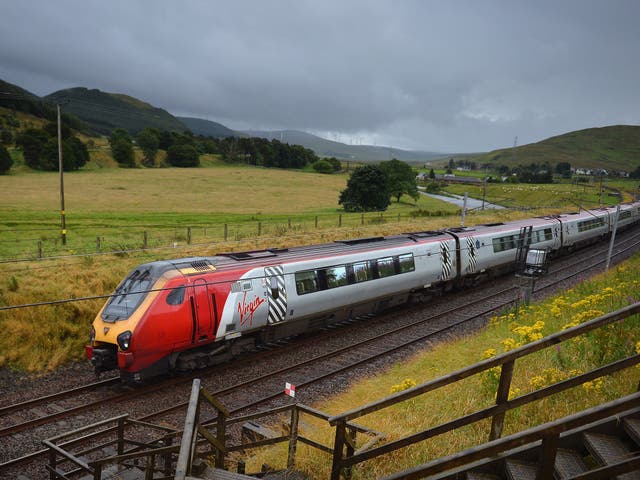 A Virgin train passes along the West Coast Main Line near Abington in Scotland