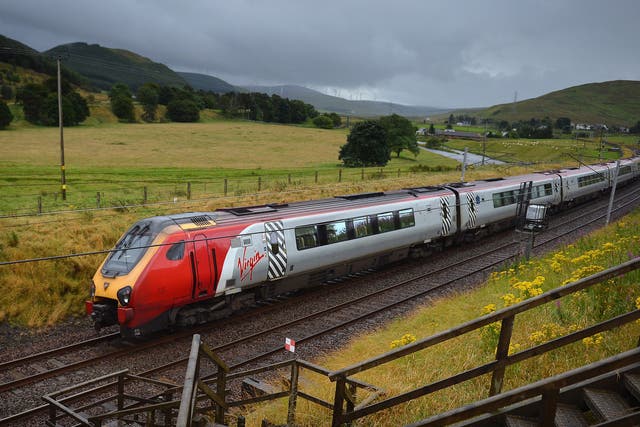 A Virgin train passes along the West Coast Main Line near Abington in Scotland