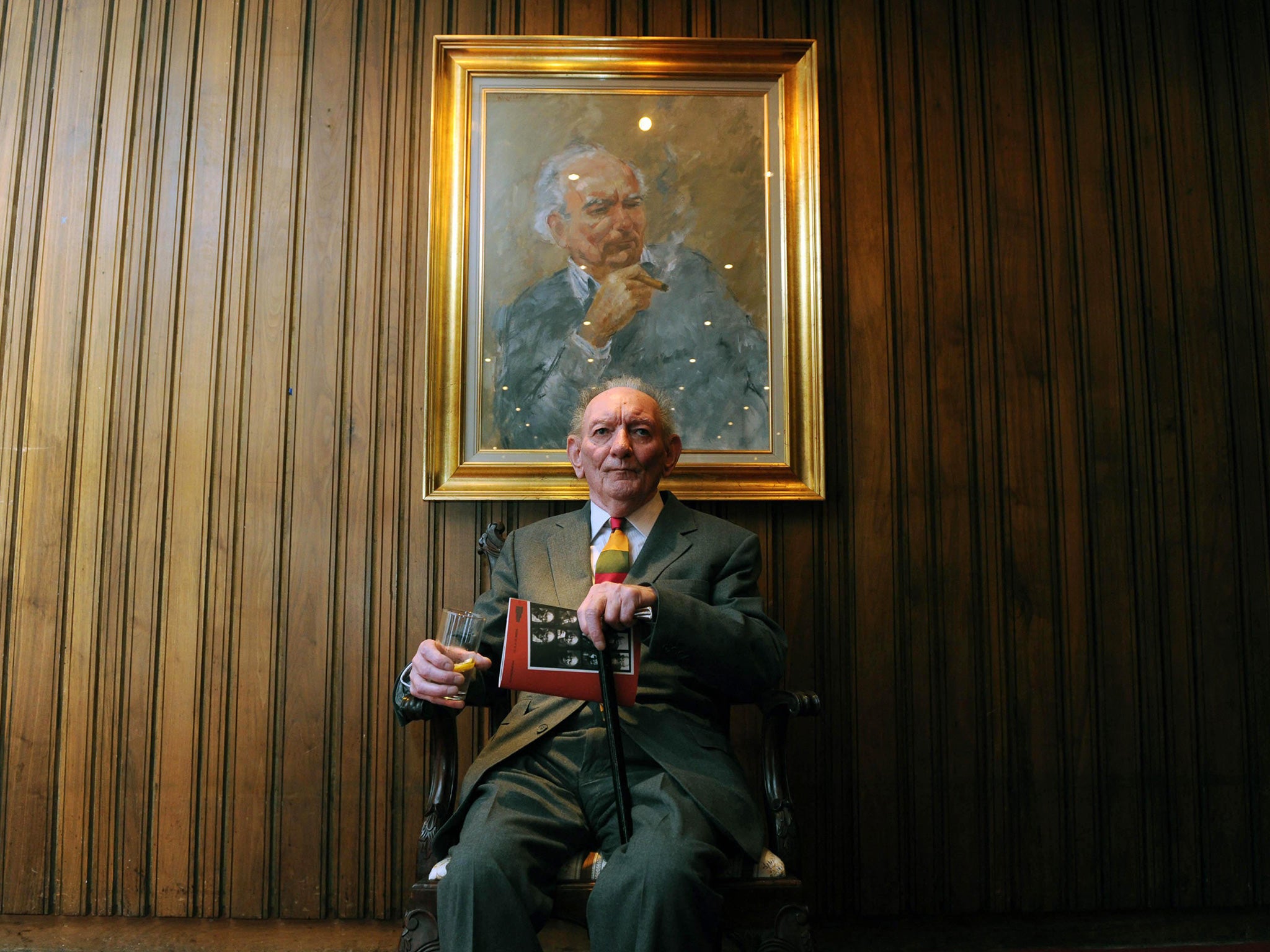 Friel, far left, in 2009 beneath a portrait of himself at Dublin’s Abbey Theatre