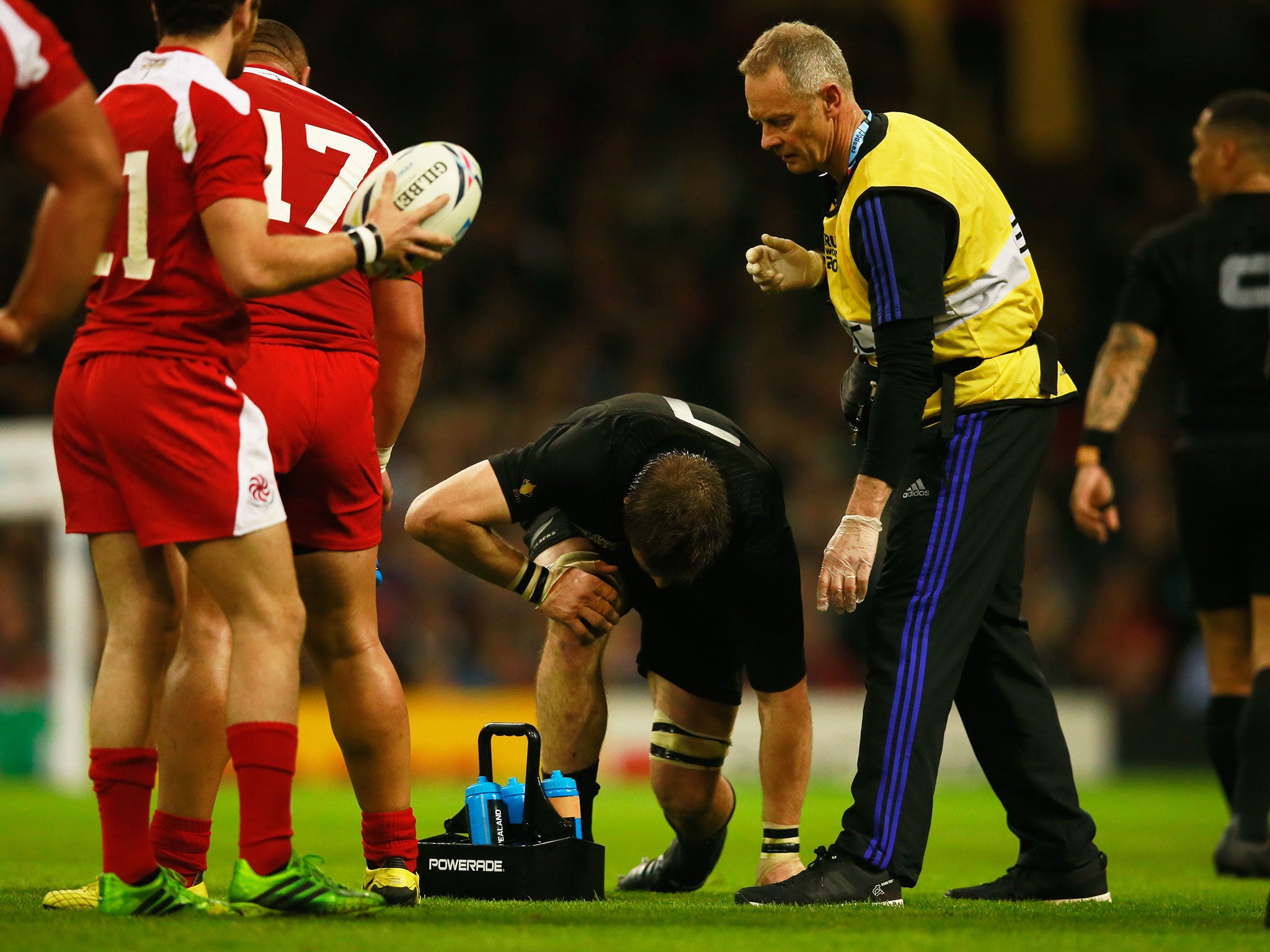 Richie McCaw receives treatment before limping off