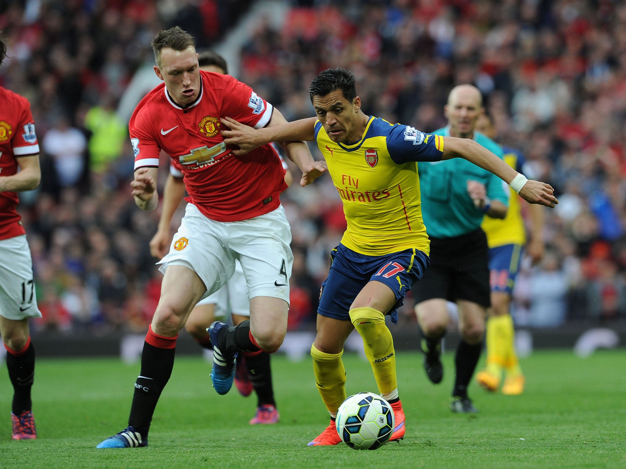 Phil Jones and Alexis Sanchez compete for the ball during Manchester United vs Arsenal