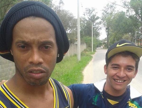 A shaken Ronaldinho poses for a selfie with the fan