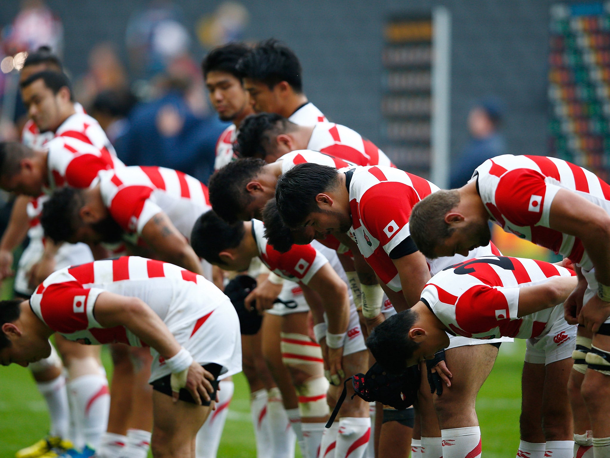 Japanese players bow to thank their fans after the convincing victory