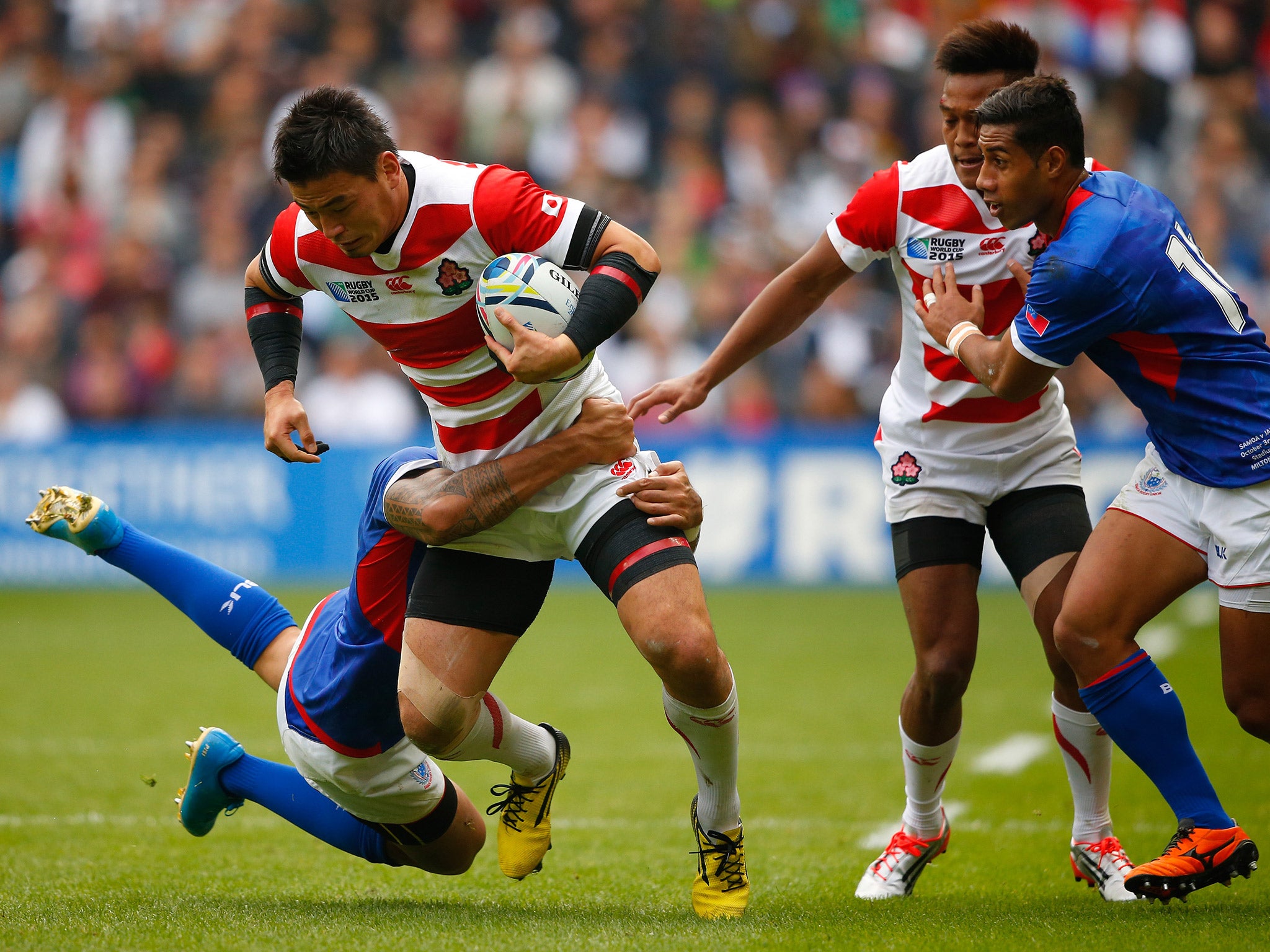 Japan's Ayumu Goromaru is tackled by Kahn Fotuali'i of Samoa