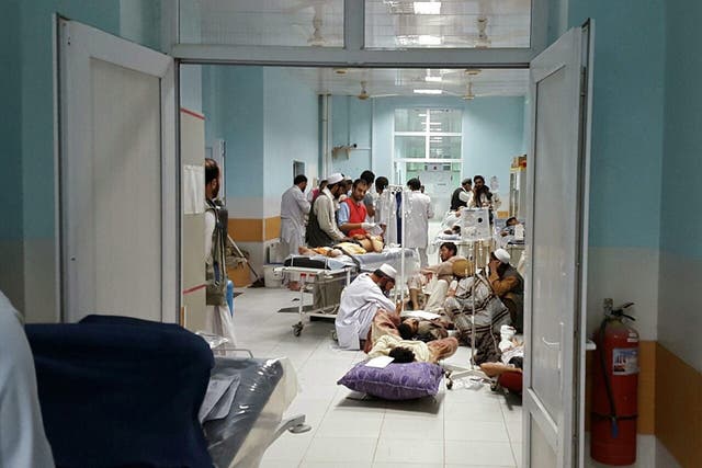 Doctors from Médecins Sans Frontières treat civilians injured in airstrikes against Taliban militants in Kunduz