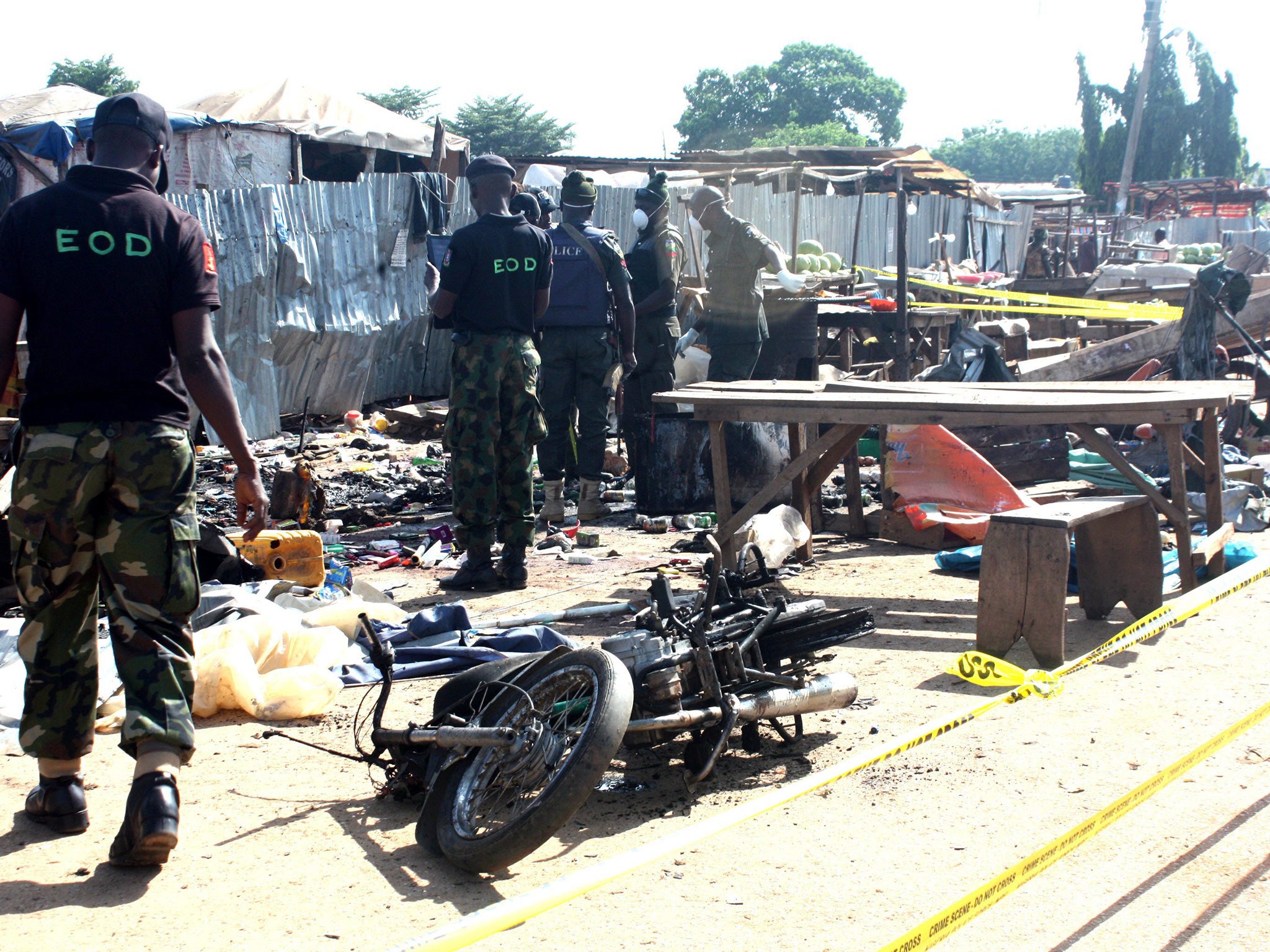 Nigeria security personnel searching the scene of the bomb blast