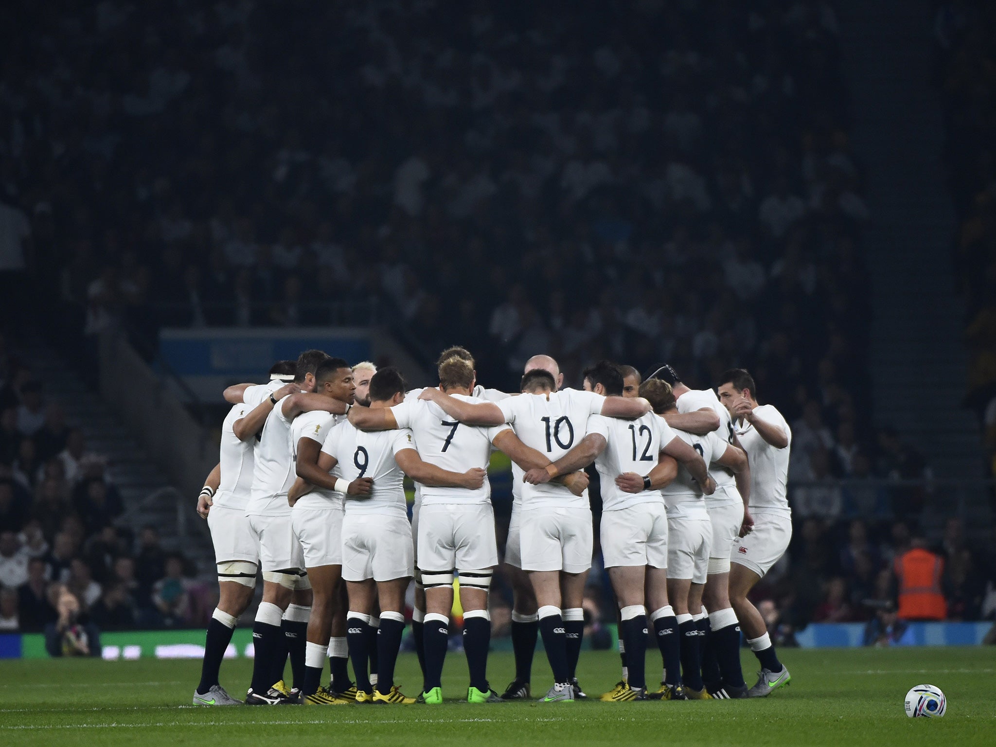 England's players huddle prior to the match against Australia at Twickenham stadium