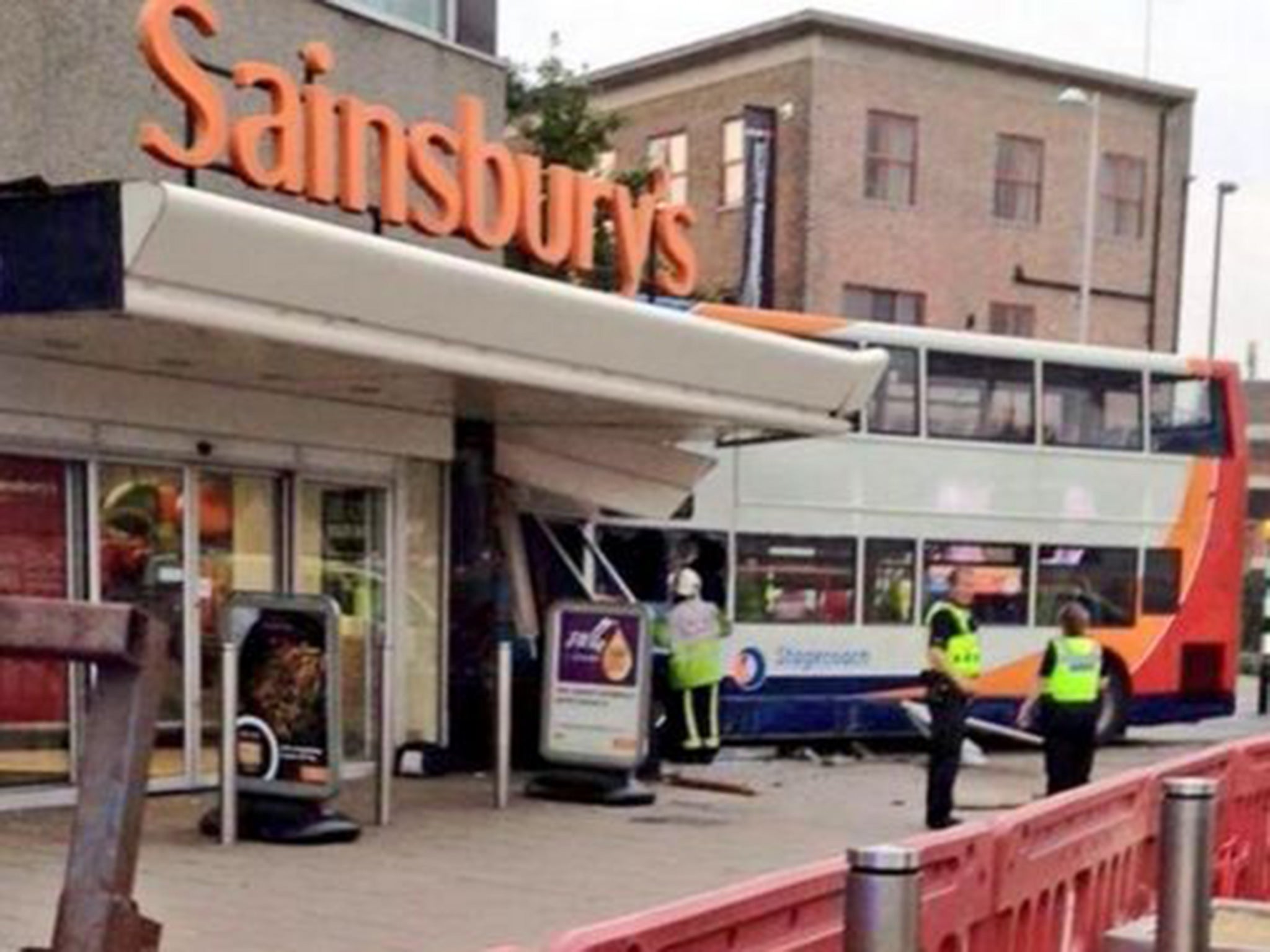 The scene where a double decker bus has crashed into a Sainsbury's supermarket on Trinity Street in Coventry