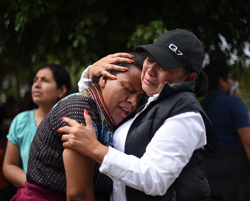 Women cry for lost loved ones outside a makeshift morgue in Guatemala City