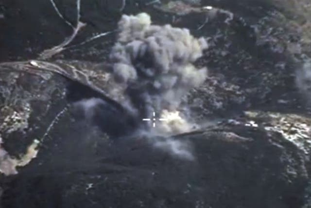 In this photo made from the footage taken from Russian Defense Ministry official web site on Sunday, Oct. 4, 2015, an aerial view of a bomb explosion in Syria