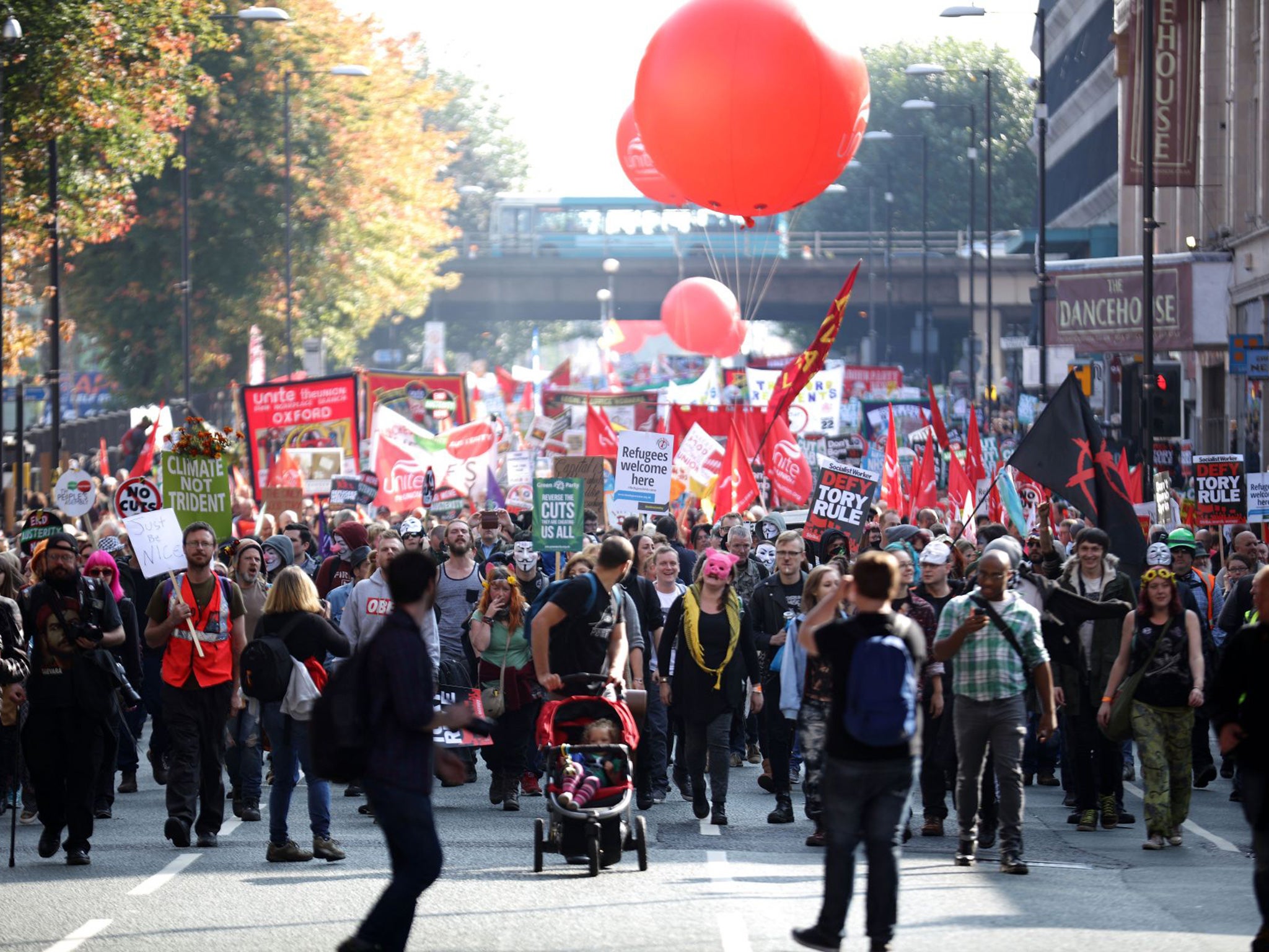 People take part in an anti-austerity protest during the first day of the Conservative Party Autumn Conference 2015 on October 4
