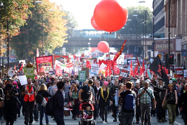 People take part in an anti-austerity protest during the first day of the Conservative Party Autumn Conference 2015 on October 4