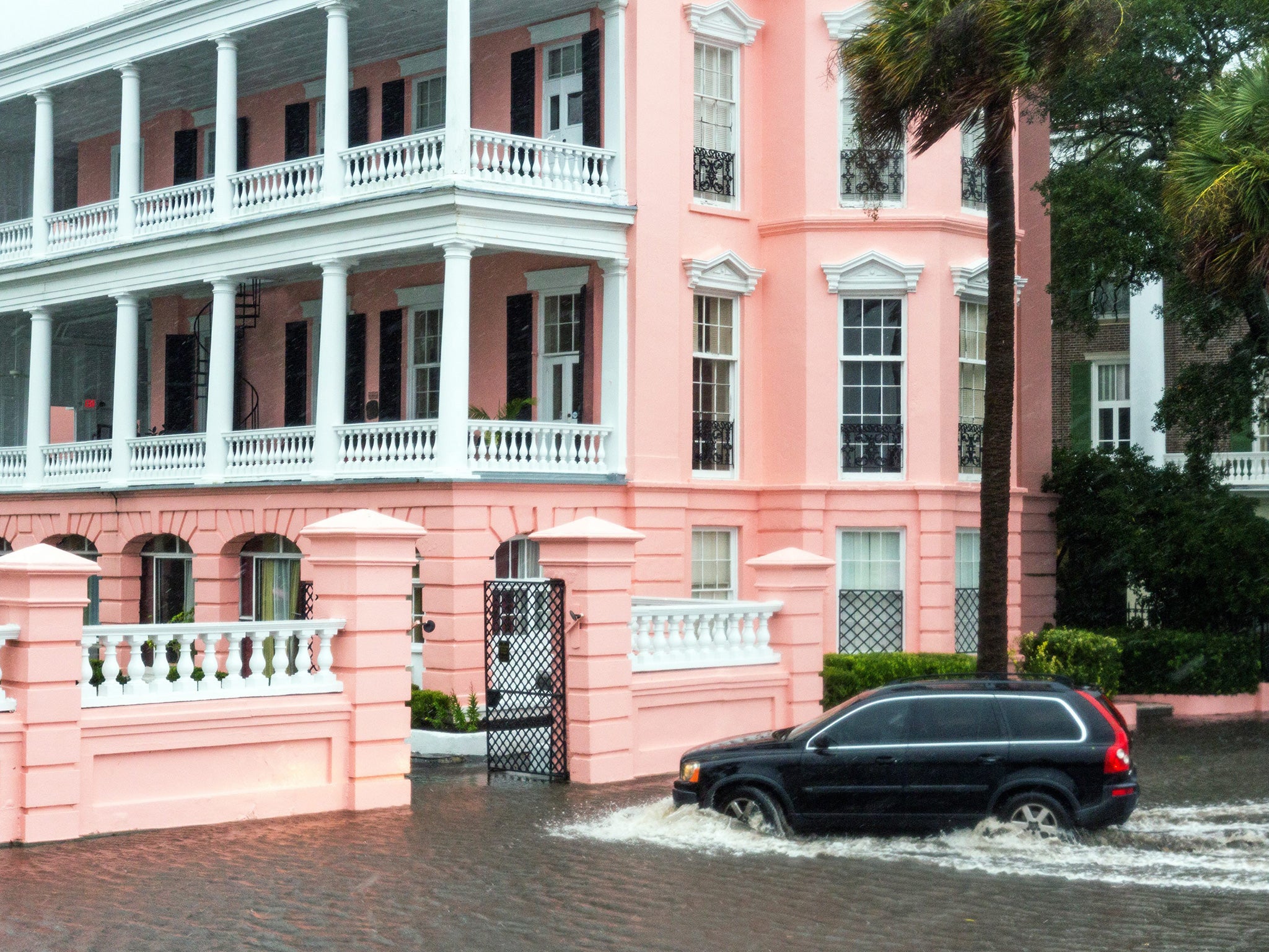 A resident drives through floodwaters to reach their home in Charleston