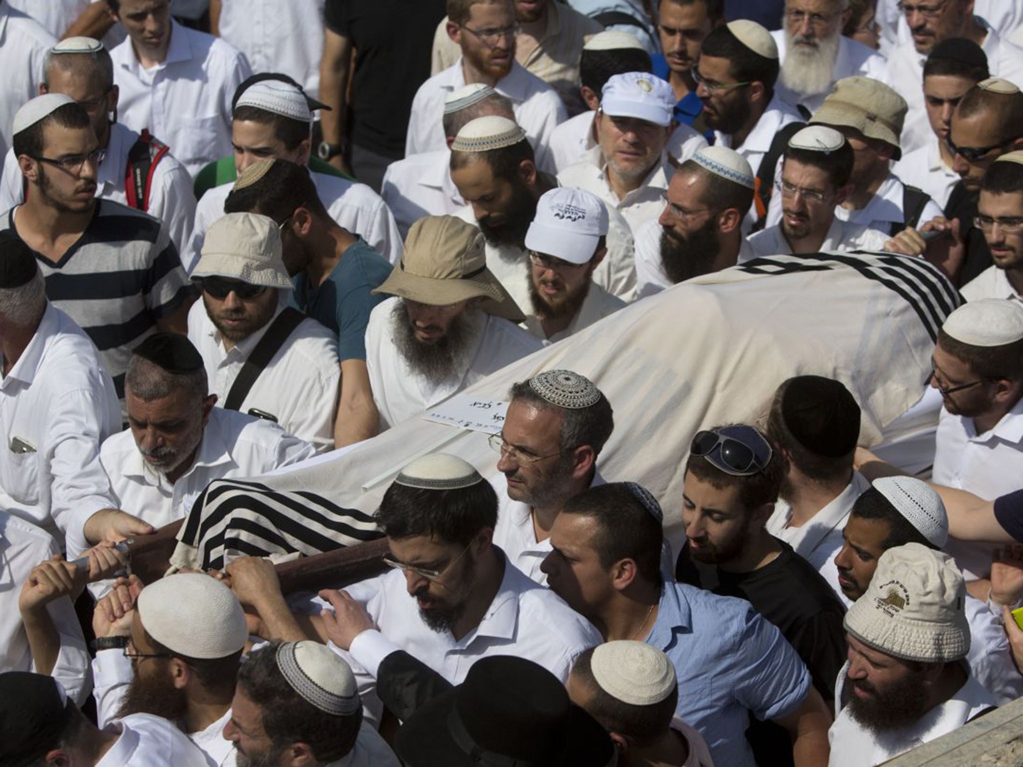 Israeli relatives and friends carry the body of Rabbi Nehemia Lavi, during his funeral at a cemetery in Jerusalem