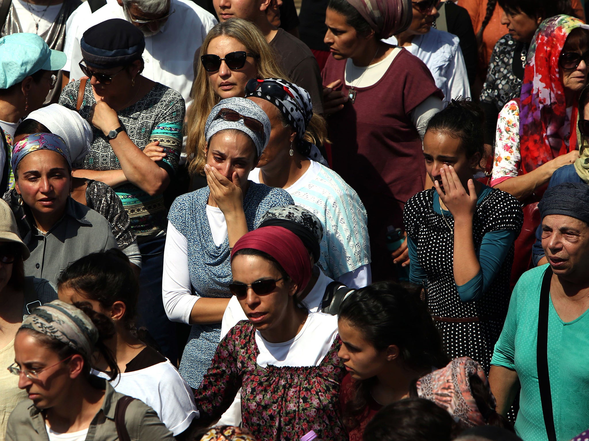 Friends and relatives of 41-year-old Israeli Nechamia Lavi, who was killed when he rushed to help victims of a knife attack carried out by a Palestinian man the night before, mourn during his funeral ceremony on October 4,2015