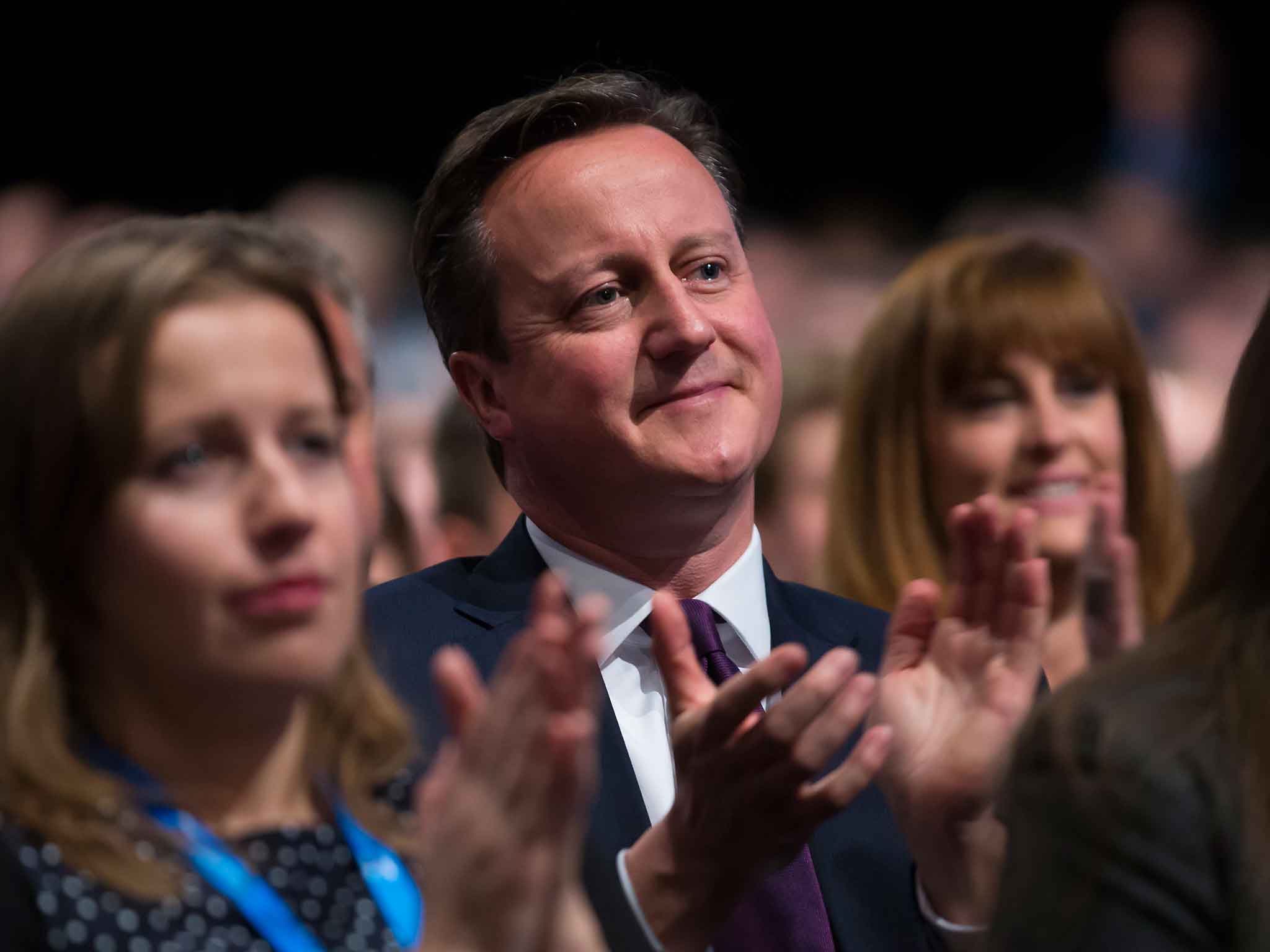 David Cameron applauds after listening to George Osborne's speech