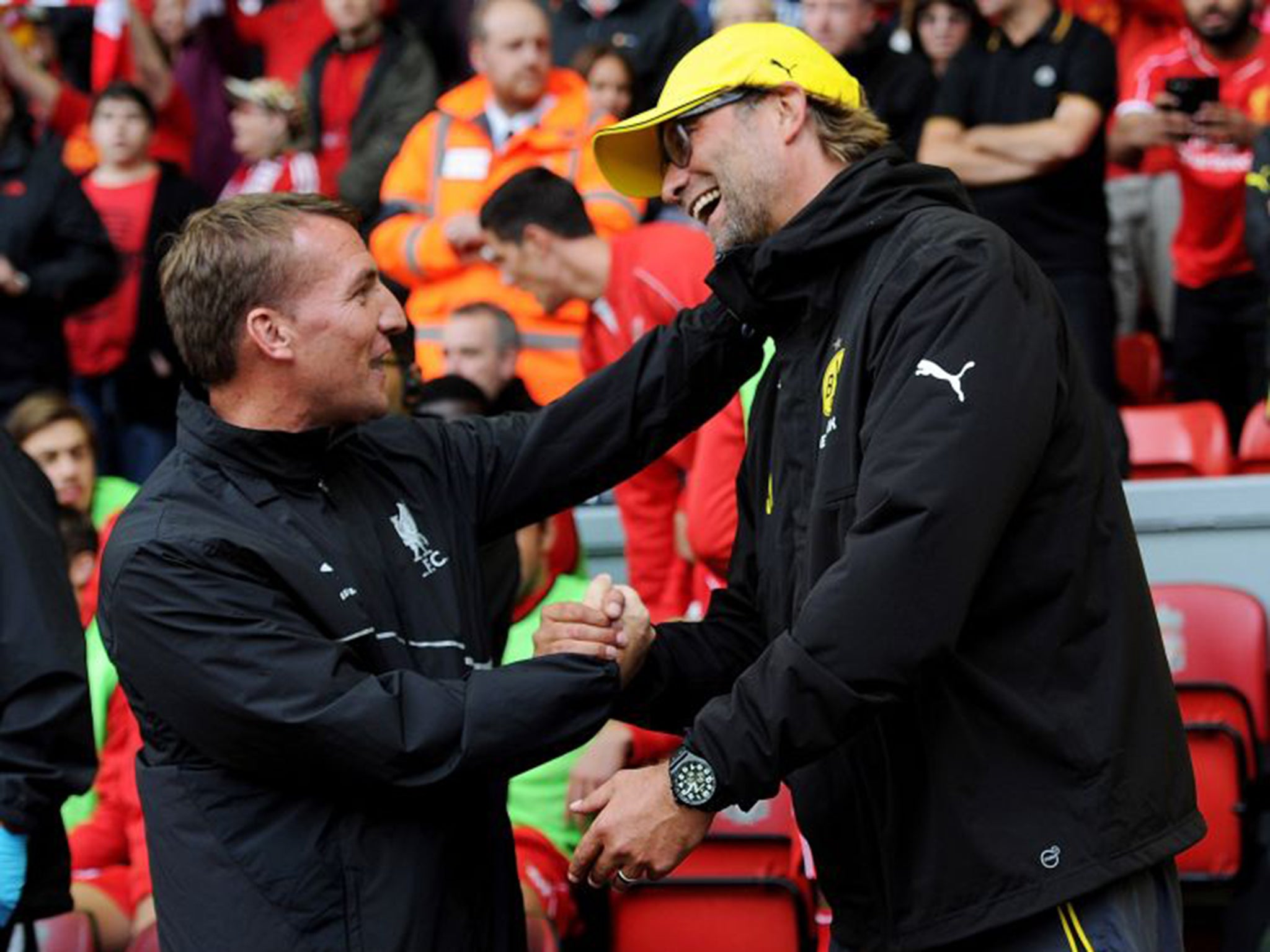 Brendan Rodgers, left, shakes hands with Jürgen Klopp before a friendly between Liverpool and Borussia Dortmund at Anfield last year