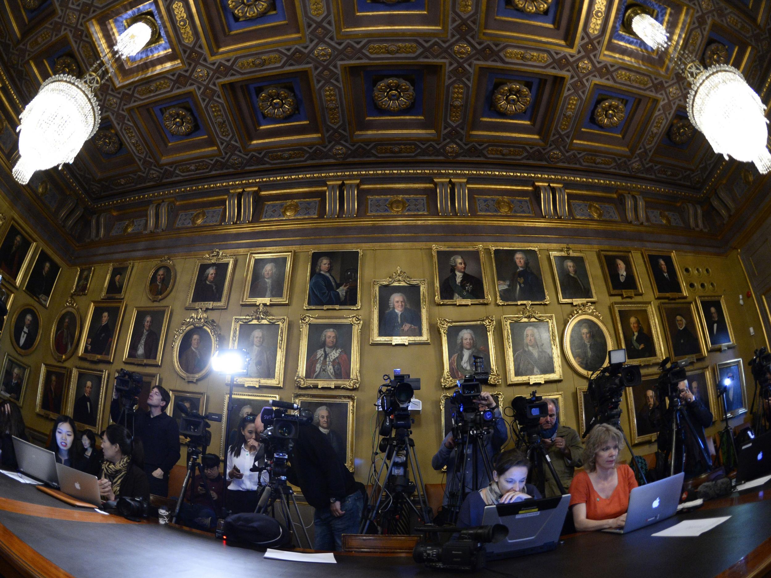 Journalists wait for the beginning of a press conference of the Nobel Committee to announce the winner of the 2015 Nobel Prize in Physics on October 6, 2015 at the Swedish Academy of Sciences in Stockholm, Sweden