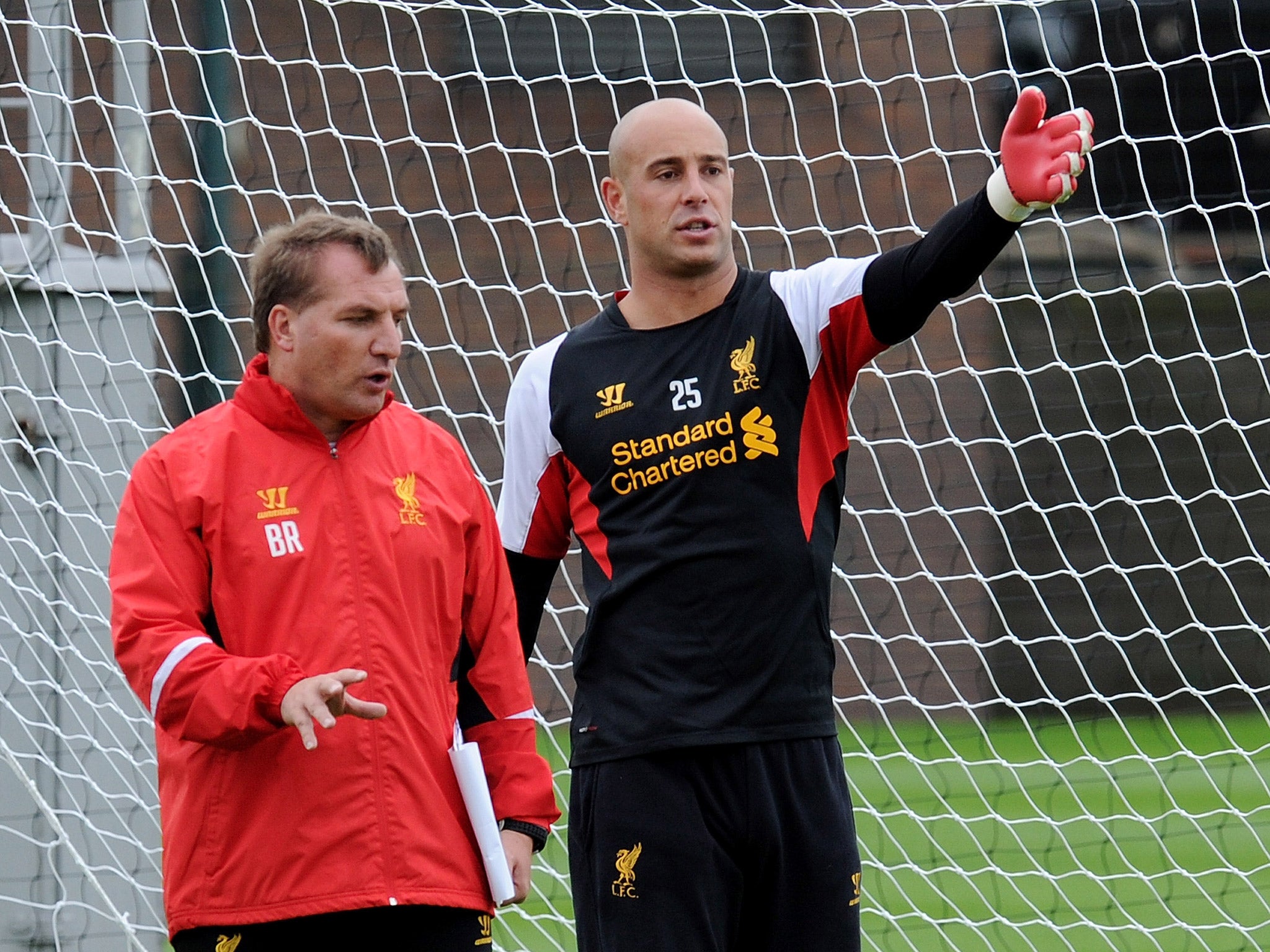 Rodgers, left, and Reina have a discussion during a training session in 2012