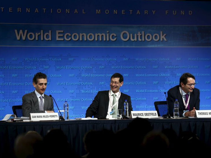 Gian Maria Milesi-Ferretti, Deputy Director, Research Department of IMF, Maurice Obstfeld Economic Counsellor and Director, Research Department of IMF and Thomas Helbling, Division Chief, Research Department of IMF (L-R) deliver the International Monetary Fund's media briefing on the world economic outlook during its annual meeting in Lima, Peru, October 6, 2015