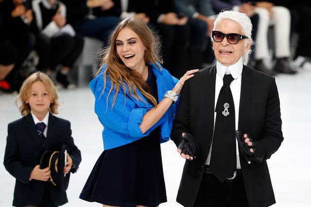 German designer Karl Lagerfeld and model Cara Delevingne appear at the end of his Spring/Summer 2016 women's ready-to-wear collection for fashion house Chanel