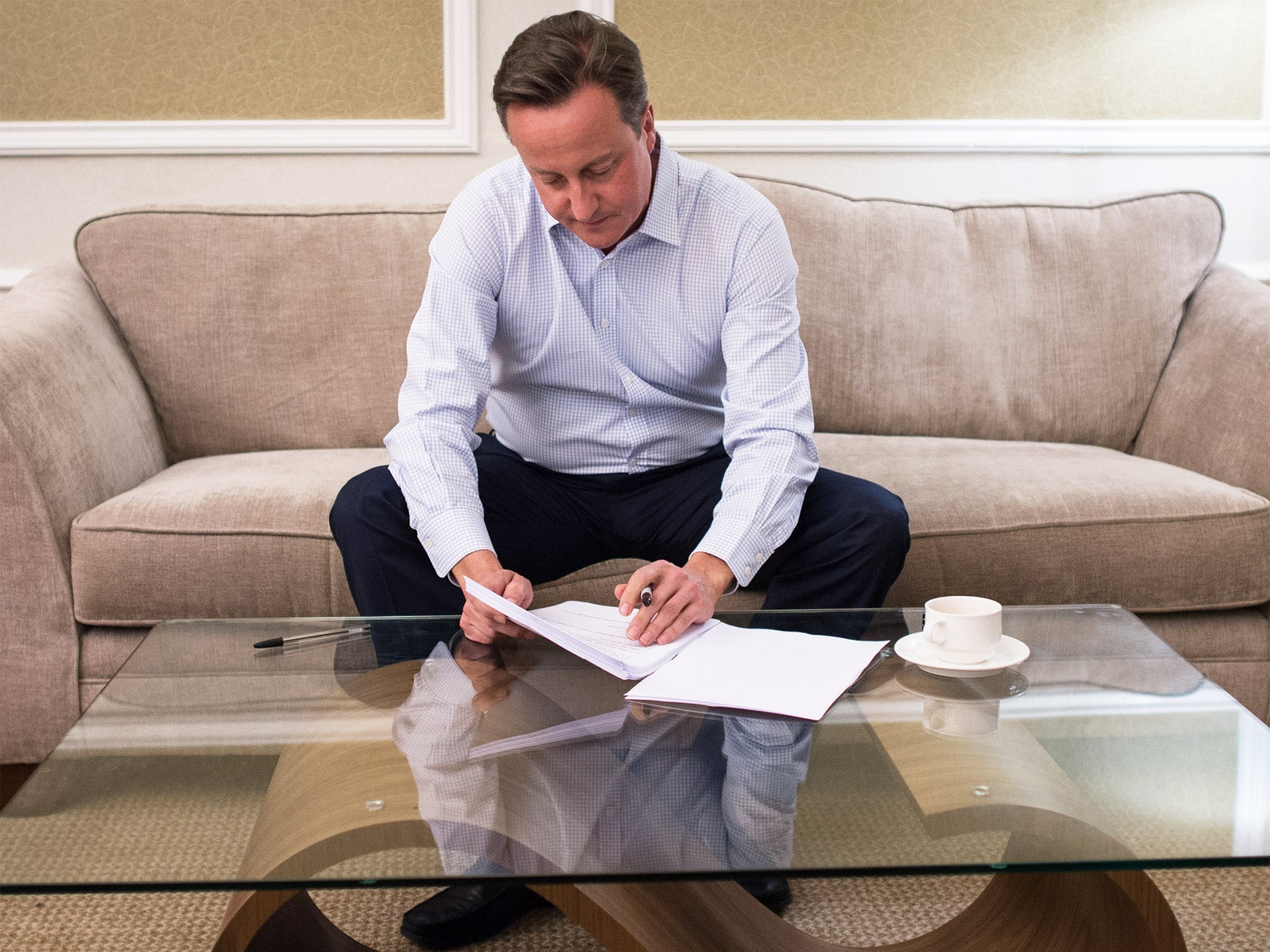 David Cameron prepares his conference speech in his Manchester hotel room last night