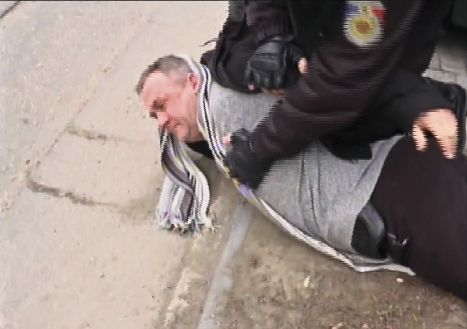 A police officer arrests Valentin Grossu during a cesium smuggling sting operation in Chisinau, Moldova