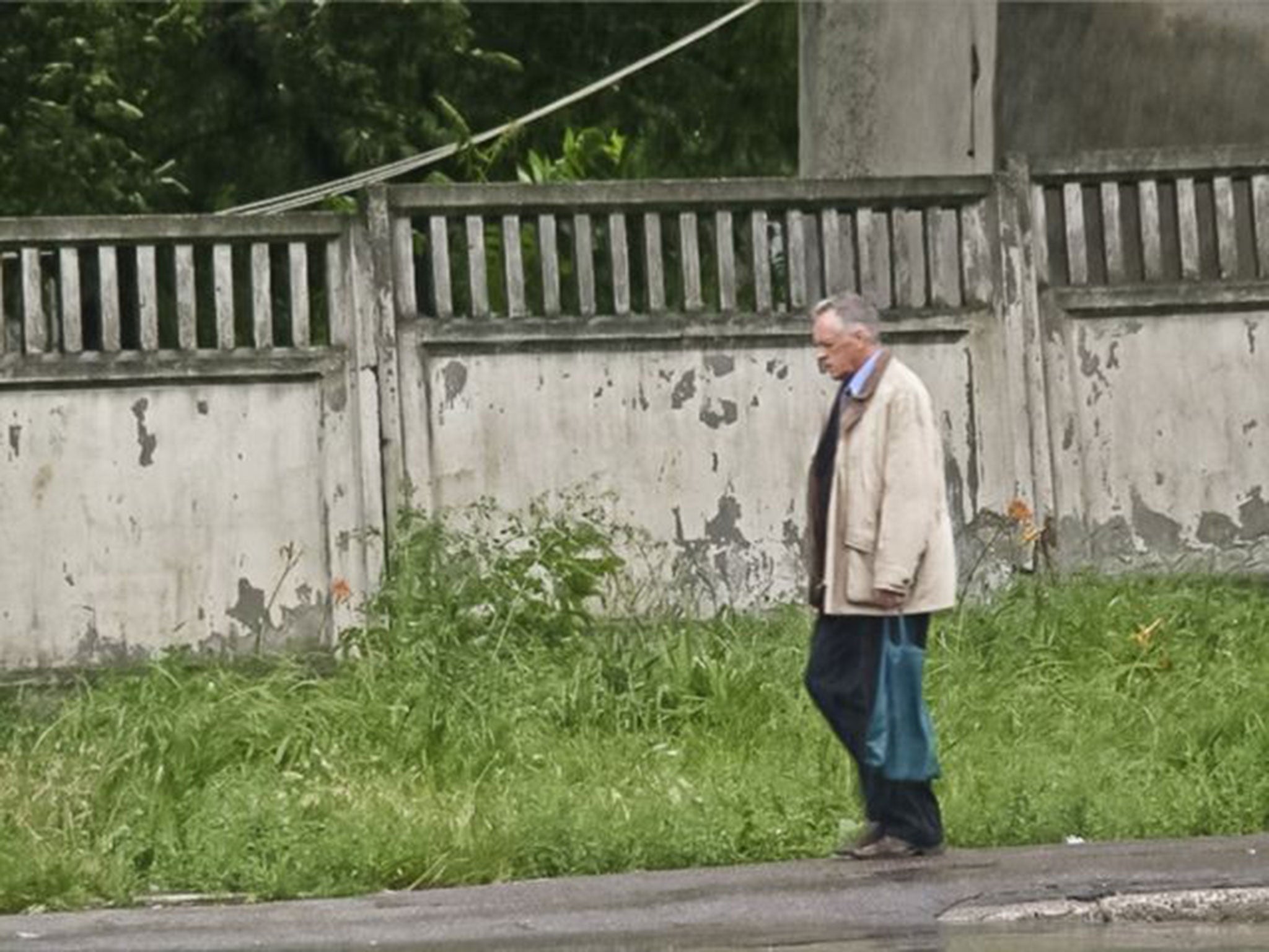 Teodor Chetrus carries a green sack containing a sample of uranium-235 in Chisinau, Moldova, in 2011.