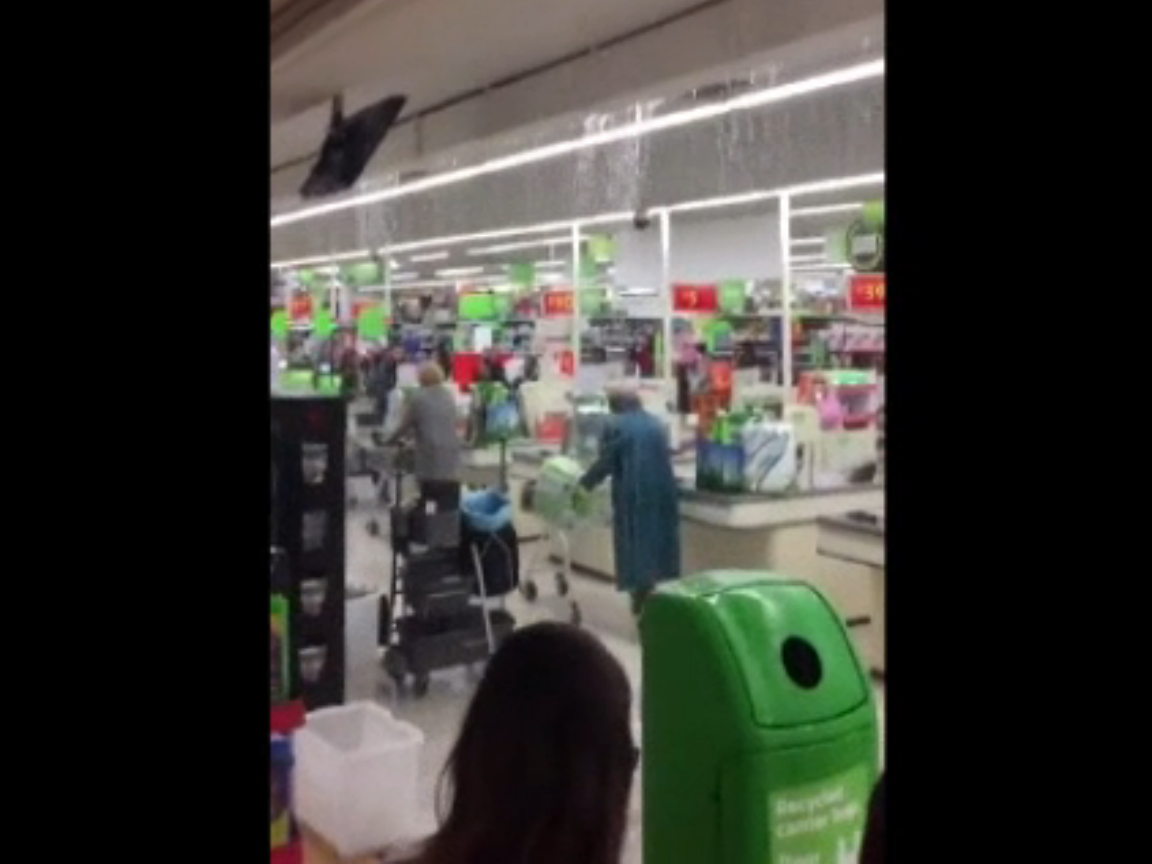 Shoppers try and escape the downpour