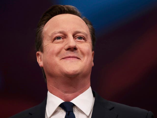 Britain's Prime Minister David Cameron smiles as he delivers his keynote address at the annual Conservative Party Conference in Manchester