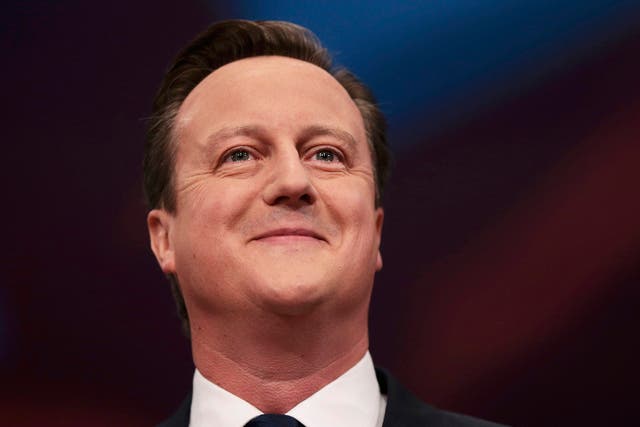Britain's Prime Minister David Cameron smiles as he delivers his keynote address at the annual Conservative Party Conference in Manchester