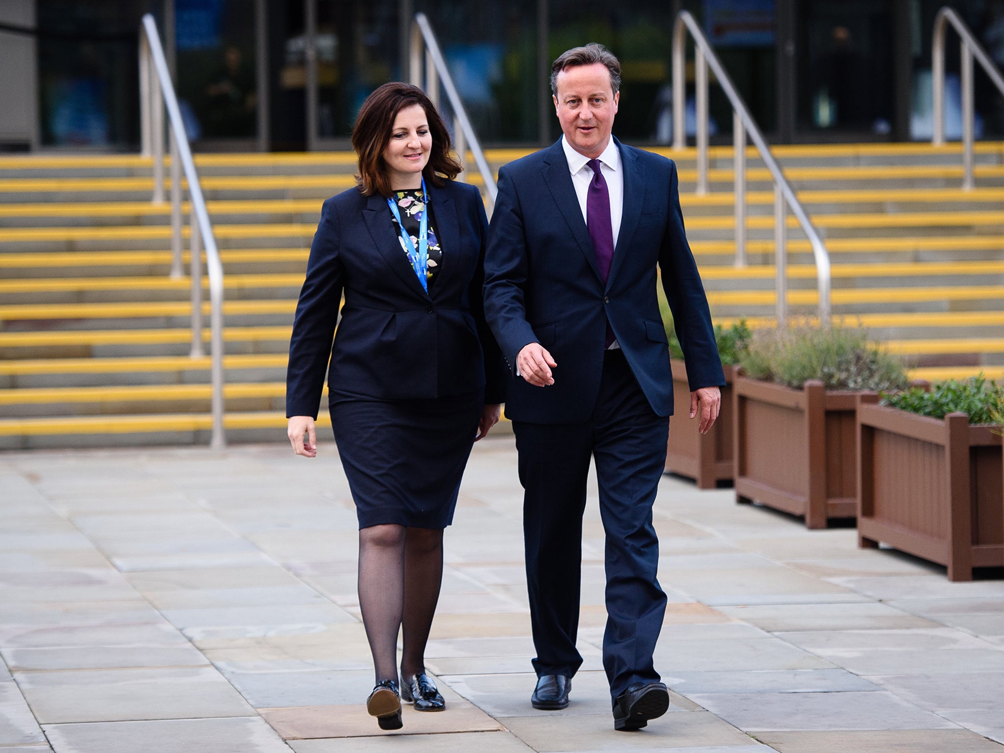 David Cameron walks from the main hall with Caroline Ansell, MP for Eastbourne and Willingdon, on the third day of the annual Conservative Party Conference in Manchester