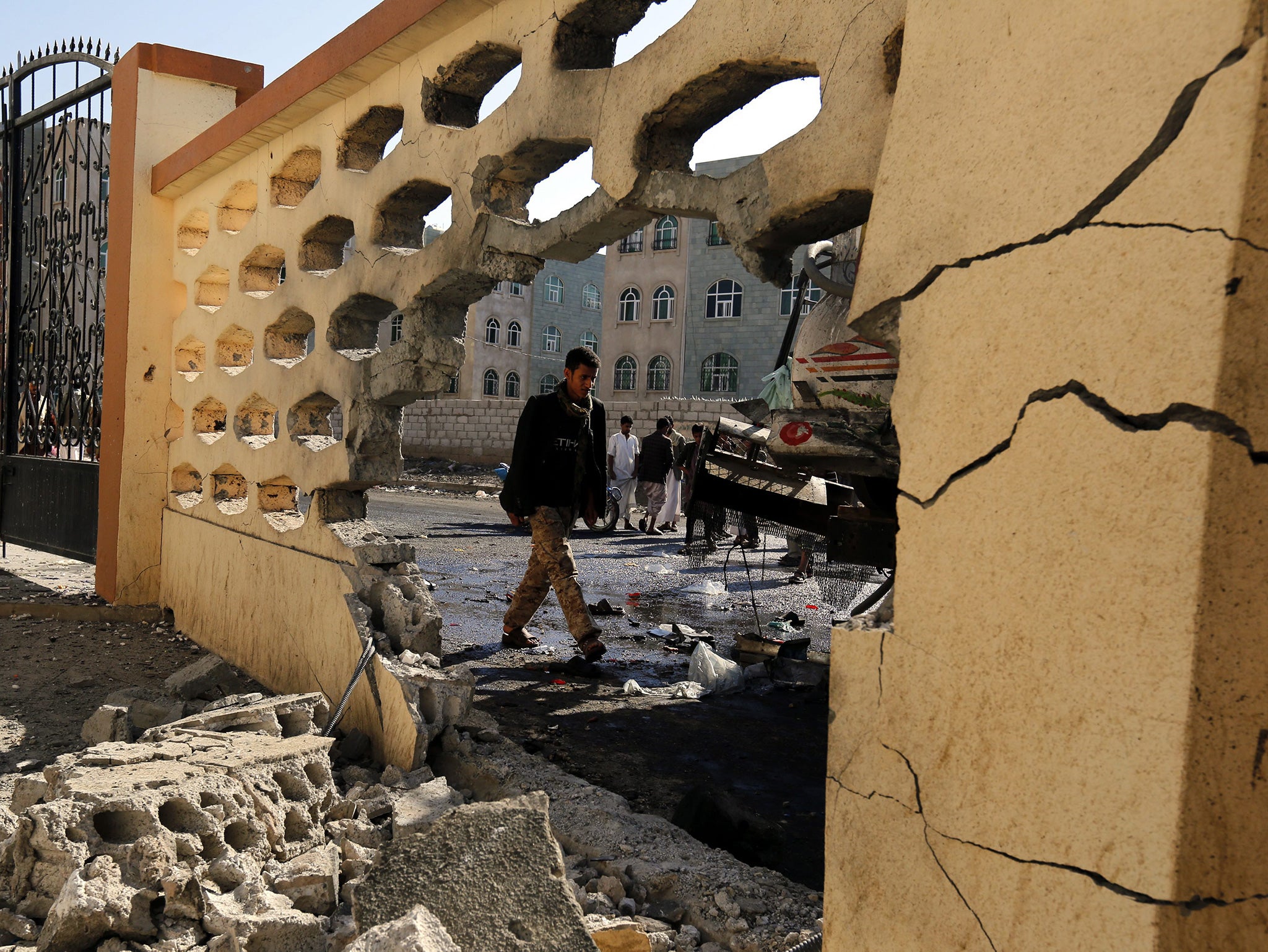 A member of the Houthi militia inspects the site of a suicide attack targeting a mosque in Sana'a, Yemen, 07 October 2015