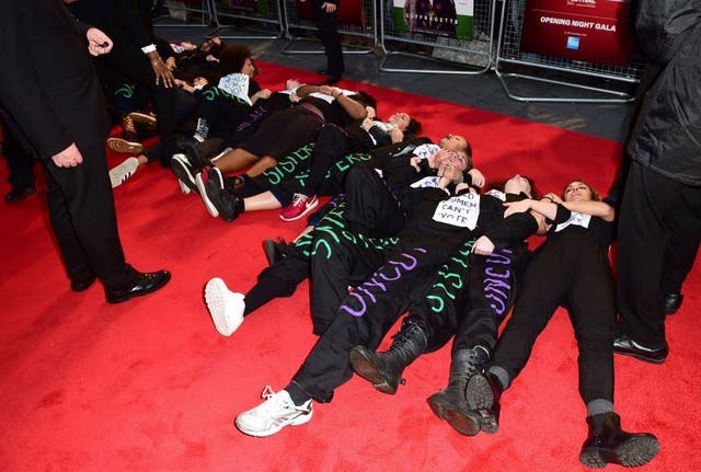 Protesters lie on the red carpet during the Suffragette Premiere