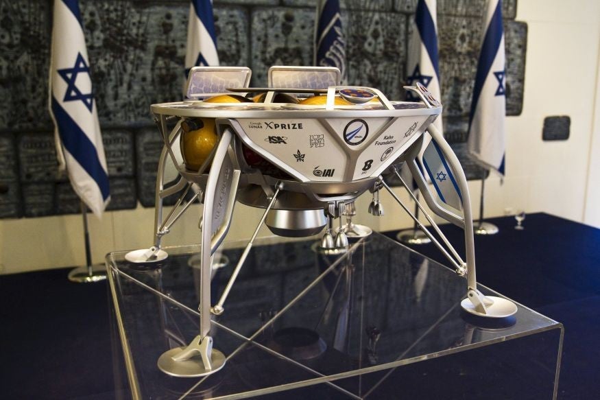 A model of an Israeli spacecraft is displayed on a podium before a meeting between Israeli President Reuven Rivlin and Israeli space team, SpaceIL