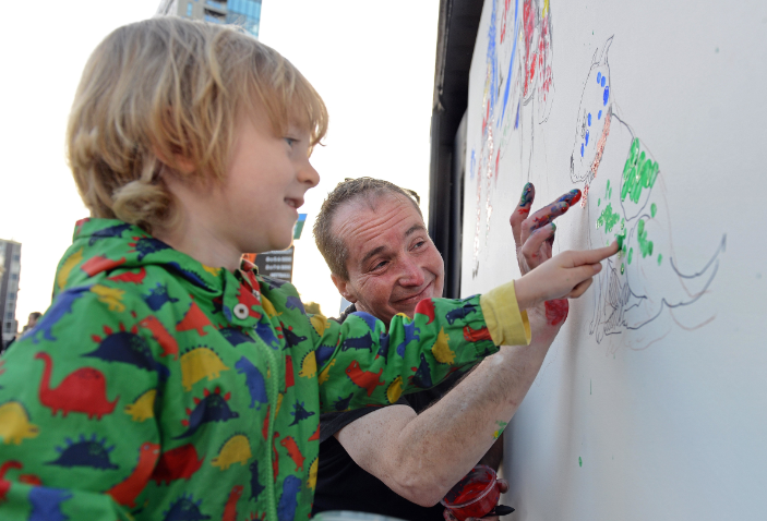 Max, 4, helping John Dolan work on At Your Fingertips