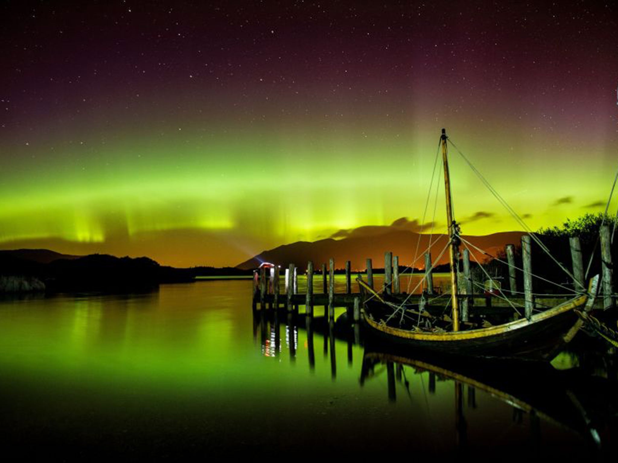 The Northern Lights, or Aurora Borealis, shine over Derwentwater, near Keswick, in the Lake District on Wednesday night