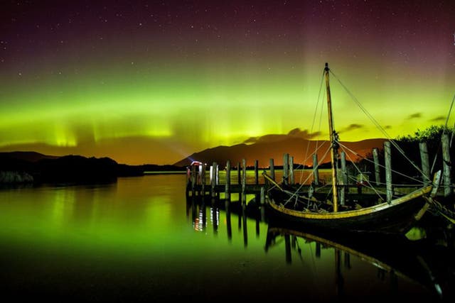 The northern lights, or Aurora Borealis, shine over Derwentwater, near Keswick, in the Lake District