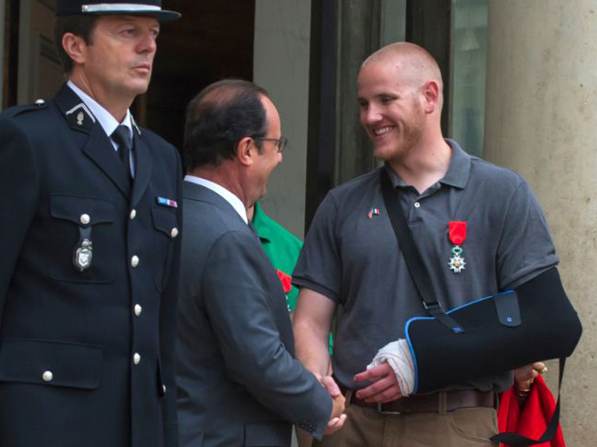 US Airman Spencer Stone shakes hands with French President Francois Hollande outside the Elysee Palace after he was awarded the French Legion of Honor for subduing a gunman on a Paris-bound train in August