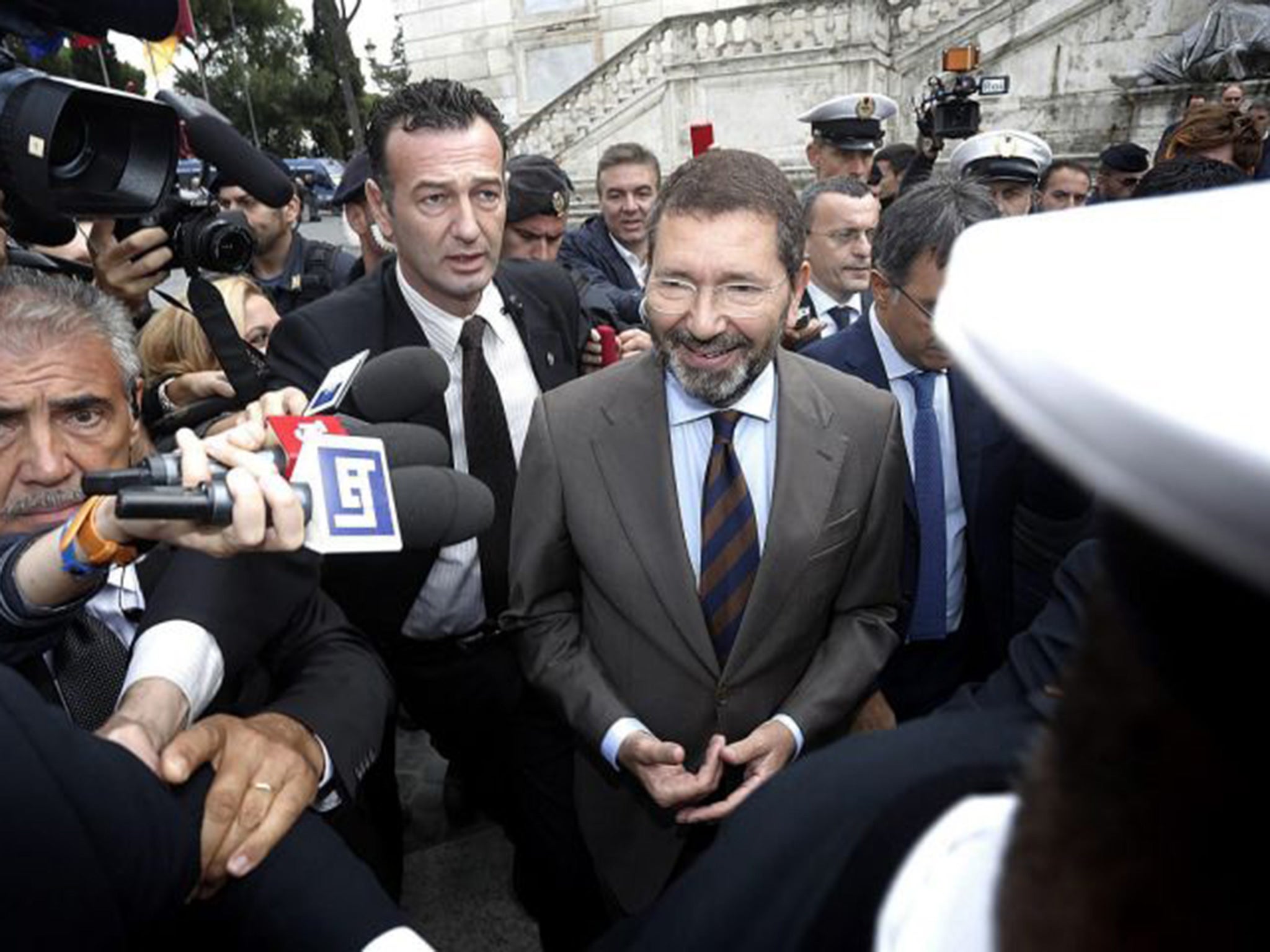 Mayor Ignazio Marino (C) arrives at the City Hall the day after his resignation