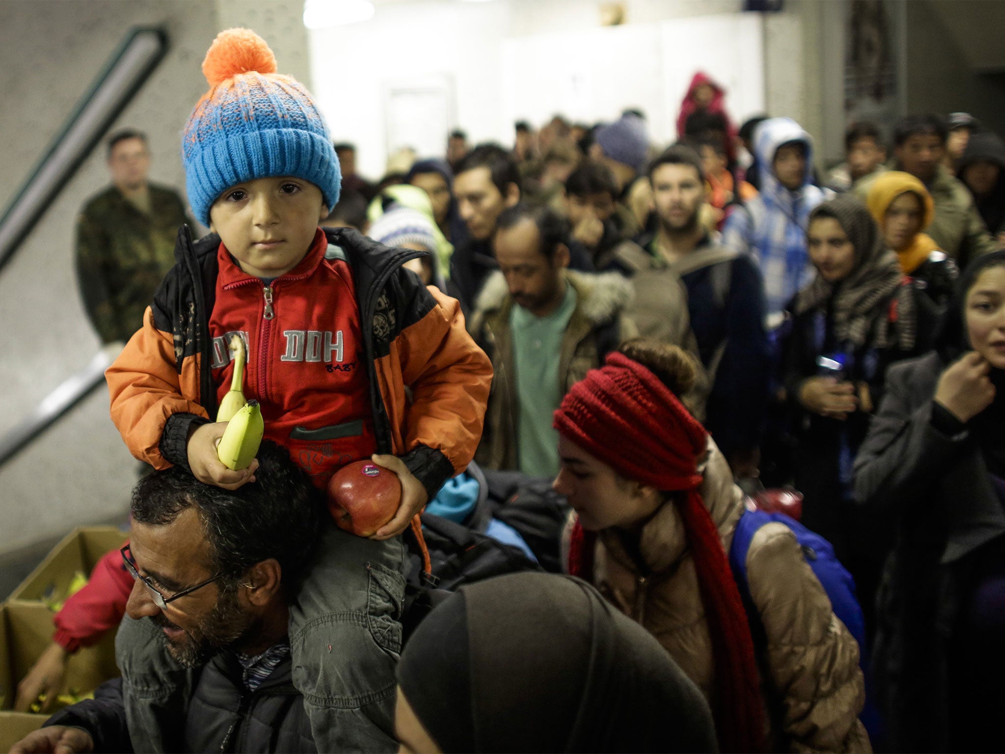 Refugees arrive by train at Schoenefeld near Berlin