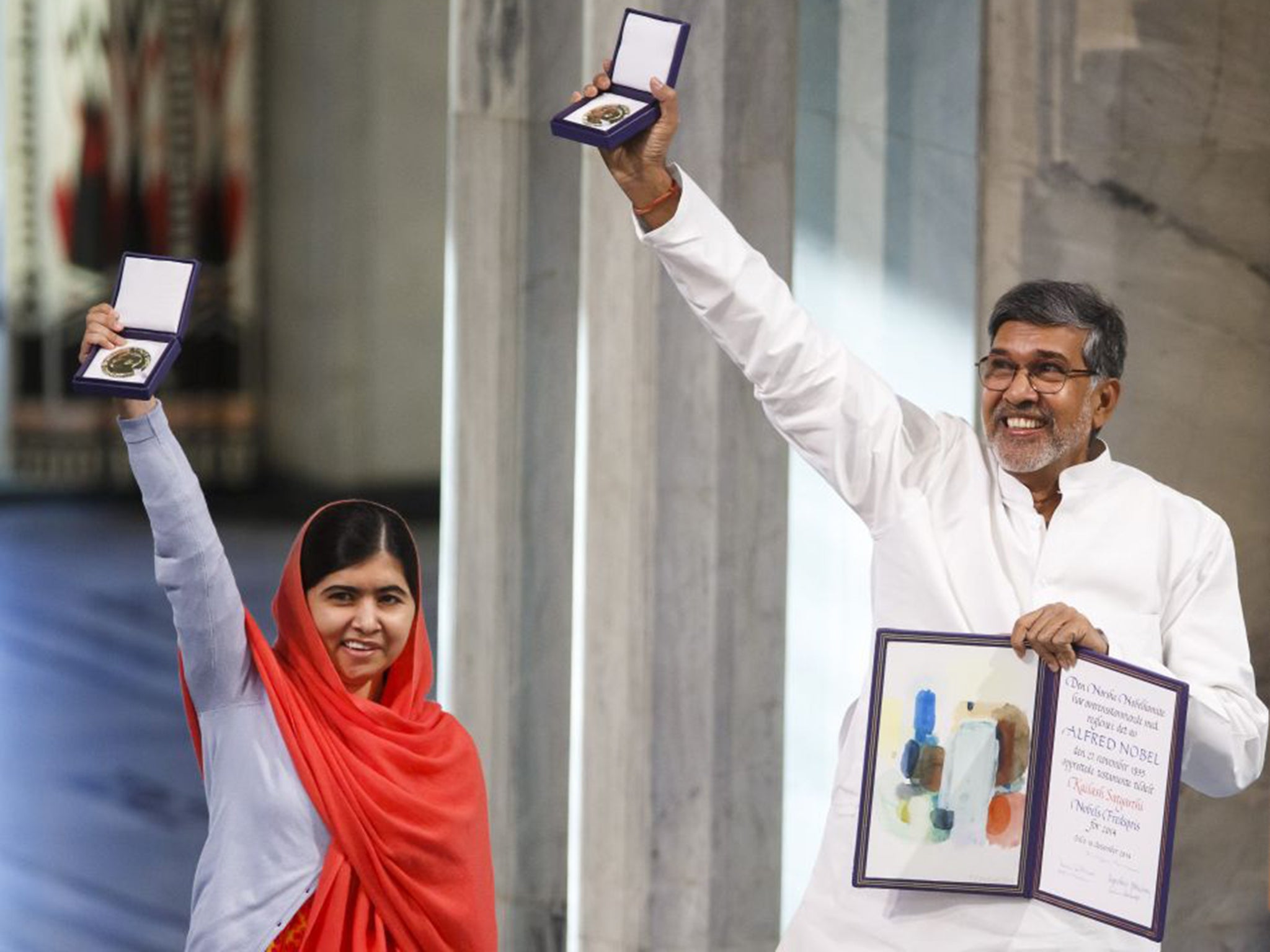 Nobel Peace Prize laureates Kailash Satyarthi, right, and Malala Yousafzai display their medals at the awards ceremony in 2014. The Pakistani activist shared the peace prize with the Indian campaigner, who has fought for 35 years to free thousands of children from virtual slave labour