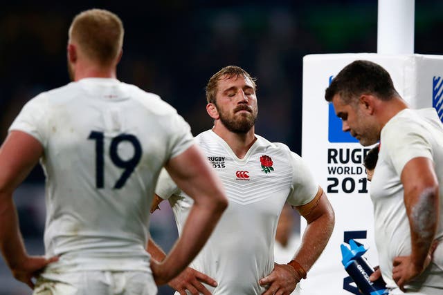 England captain Chris Robshaw, centre, looks on dejected after his side's exit from the Rugby World Cup